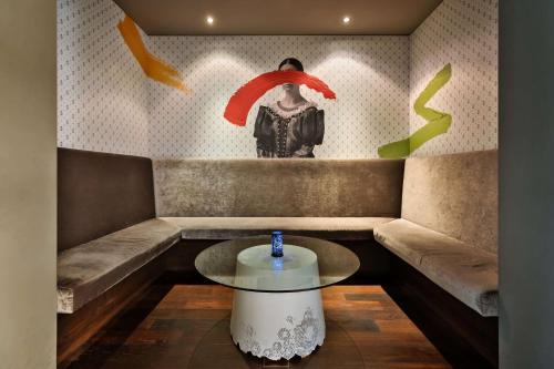 a room with a table and a painting on the wall at Doubletree by Hilton Vienna Schonbrunn in Vienna