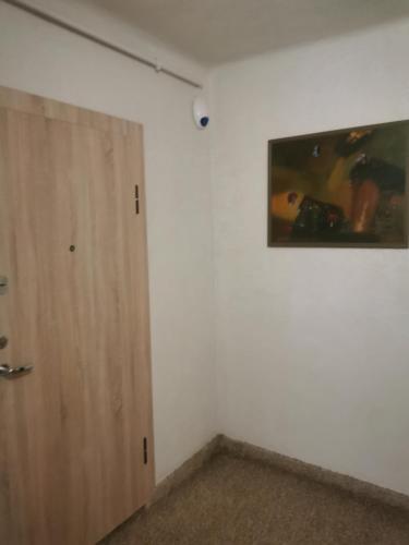 a room with a door and a picture on the wall at Charming Apartment in Kaunas Old Town with Balcony in Kaunas