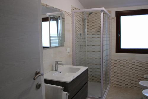 a bathroom with a sink and a shower at Casa Bel Panorama in Orosei