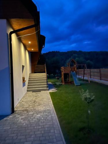 a house with a playground in the yard at Apartamenty Ogrodowa in Ujsoły