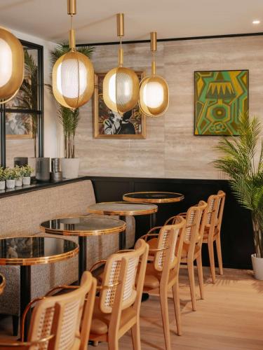 a row of tables and chairs in a restaurant at Marty Hotel Bordeaux - Tapestry Collection by Hilton in Bordeaux