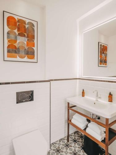 a bathroom with a sink and a mirror at Marty Hotel Bordeaux - Tapestry Collection by Hilton in Bordeaux