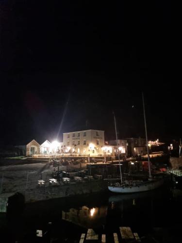 a group of boats docked in a harbor at night at Lucie’s Escape/ 129 meadow view in Grampound