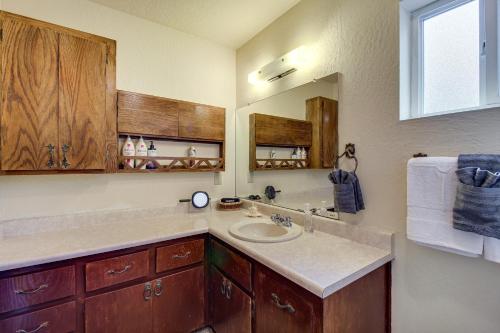 a bathroom with a sink and a mirror at Furnished Porch and Gas Grill Lakeside Cottage Stay in Pinetop-Lakeside