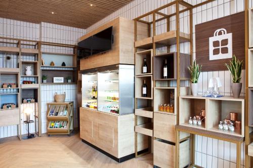 a wine tasting room with wooden shelves at Hilton Garden Inn Munich Messe in Feldkirchen
