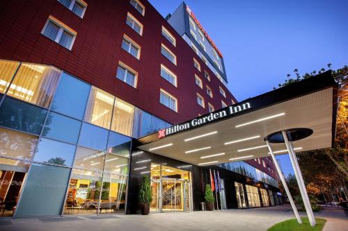 a building with a hospital cancer line sign in front of it at Hilton Garden Inn Tirana in Tirana