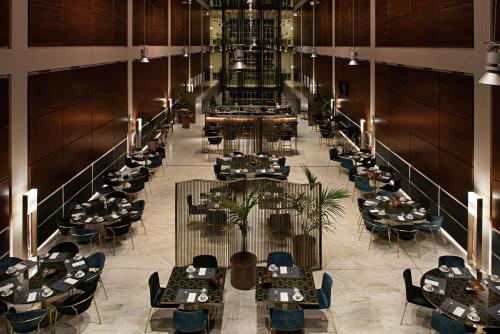 an overhead view of a restaurant with tables and chairs at DoubleTree by Hilton Turin Lingotto in Turin