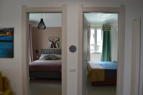 a bedroom with a bed and a door leading to a bedroom at Futtitinni Home casamia in Palermo