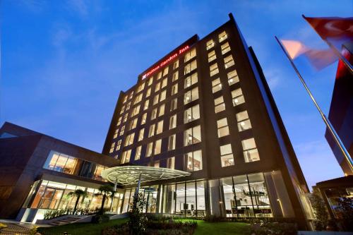 a hotel building with a red sign on it at Hilton Garden Inn Istanbul Beylikduzu in Istanbul