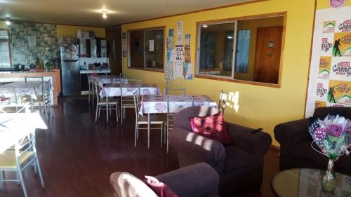 a dining room with tables and chairs in a restaurant at Hostel Chango in Caldera
