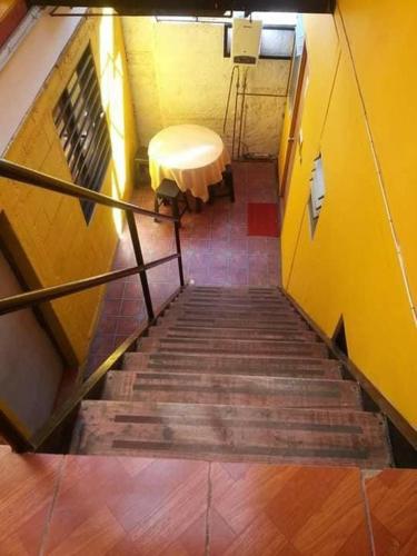 a view of a staircase with a table and a bench at Hostel Chango in Caldera