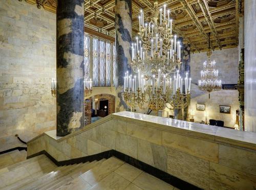 a large lobby with chandeliers in a building at Hilton Moscow Leningradskaya in Moscow