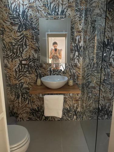 a woman taking a picture in a bathroom mirror at Dimora Agnese in Casalabate