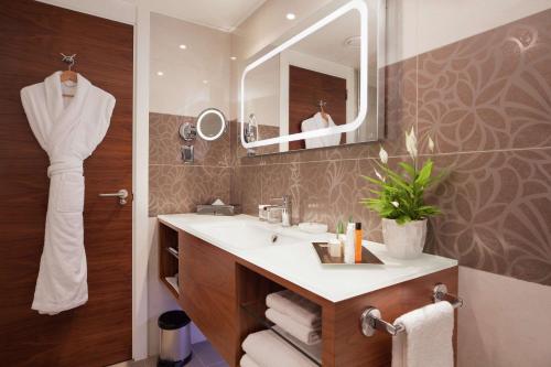 a bathroom with a sink and a mirror at Hilton Barcelona in Barcelona