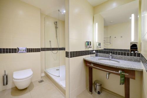 a bathroom with a toilet and a sink and a shower at Hampton by Hilton Volgograd Profsoyuznaya in Volgograd