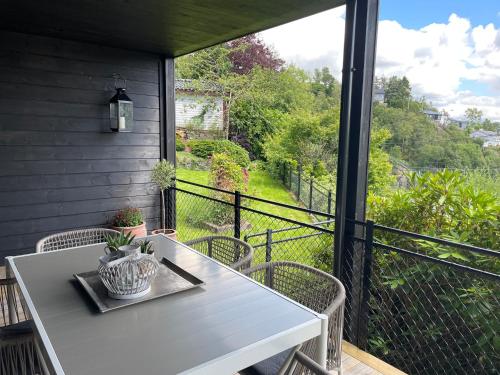 a white table and chairs on a balcony with a view at Apartments Bergen with sea view! in Bergen