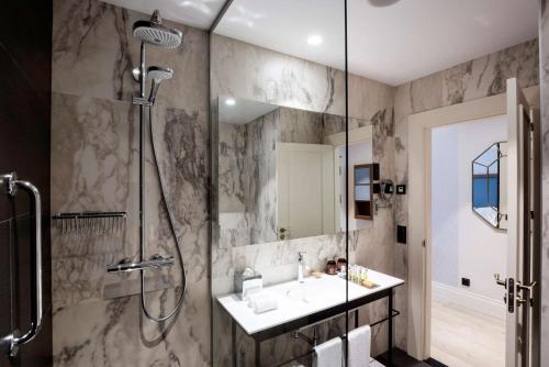a bathroom with a shower and a sink at DoubleTree by Hilton Madrid-Prado in Madrid