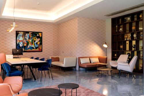 a restaurant with tables and chairs in a room at Doubletree by Hilton Milan Malpensa Solbiate Olona in Solbiate Olona