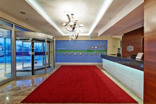 a lobby with a red carpet in a building at Hampton By Hilton Ordu in Ordu