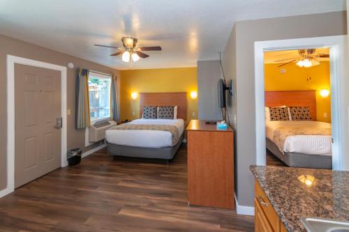 a hotel room with two beds and a kitchen at Nordic Inn and Suites in Portland