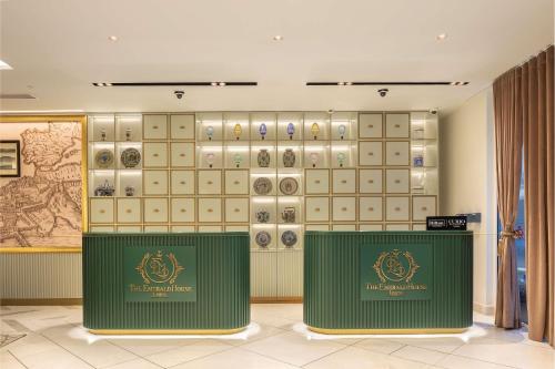 a room with a wall of lockers andaques on the wall at The Emerald House Lisbon - Curio Collection By Hilton in Lisbon