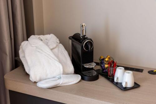 a counter with towels and a hair dryer on it at Hilton Garden Inn Paris Massy in Massy