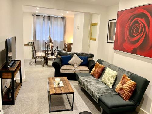 a living room with a couch and a table at 4 Bedroom Terrace house Near Town Center Wellingborough in Wellingborough