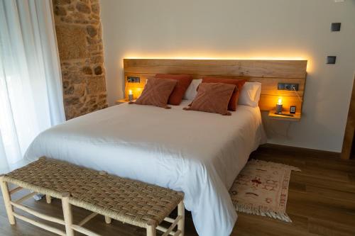 a bedroom with a large white bed with two lamps at LA ALCOBA DE SAYAGO in Bermillo de Sayago