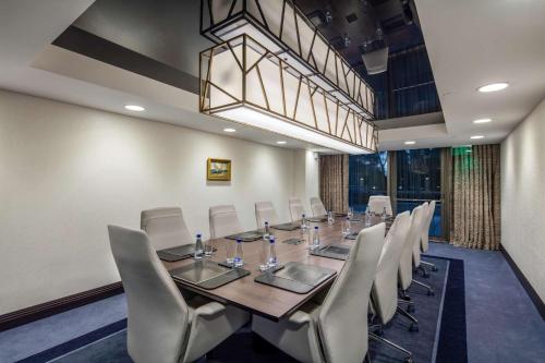 a conference room with a long table and chairs at Hilton Podgorica Crna Gora in Podgorica