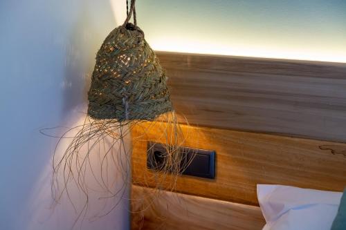 a bag hanging on the side of a bed at LA ALCOBA DE SAYAGO in Bermillo de Sayago