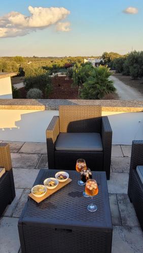 a table with a tray of food and wine glasses on it at Villa Dolce Far Niente Ostuni in Ostuni
