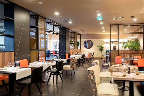 a dining room with tables and chairs and a restaurant at DoubleTree by Hilton Brescia in Brescia