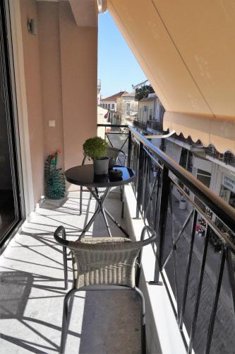a balcony with a table and a table on a balcony at Ζωή Apartment in Preveza