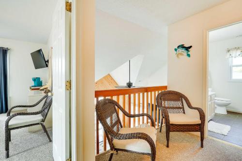 a room with two chairs and a balcony with a toilet at Hot Tub, Pirate Fort and Fire Pit Outer Banks Home! in Nags Head