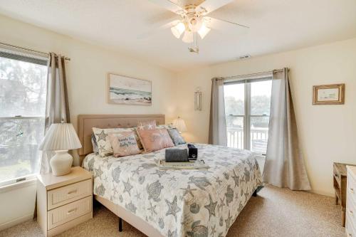 a bedroom with a bed and a ceiling fan at Hot Tub, Pirate Fort and Fire Pit Outer Banks Home! in Nags Head
