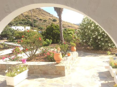 an archway with potted plants in a garden at Nicolas Studios in Skala