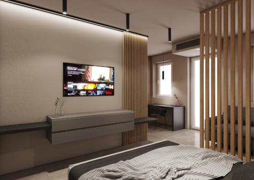 a bedroom with a bed and a television on the wall at La Pergola Suites in Dossobuono