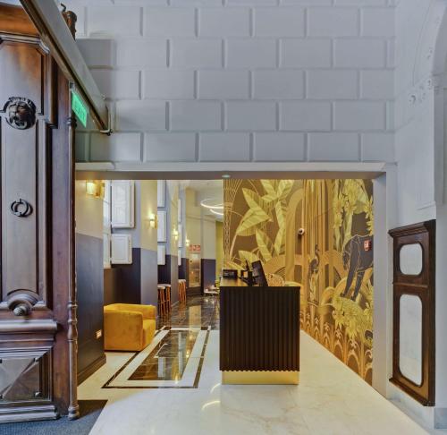 a lobby with a large painting on the wall at Casa Alberola Alicante, Curio Collection By Hilton in Alicante