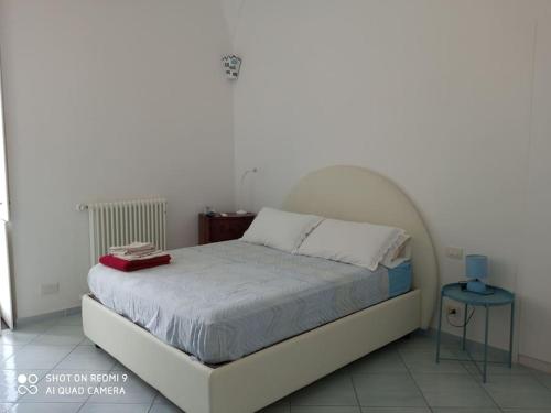 - une chambre avec un lit doté d'une tête de lit blanche dans l'établissement Casa Fiore, à Monte di Procida
