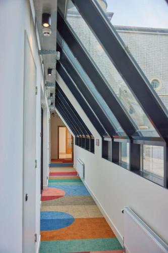 a hallway with colorful floors in a building at Motto By Hilton Rotterdam Blaak in Rotterdam