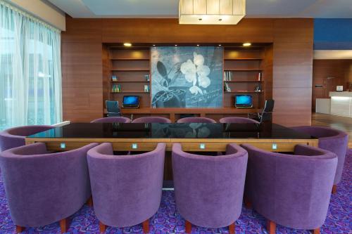 a conference room with purple chairs and a table at Hampton by Hilton Gdansk Airport in Gdańsk-Rębiechowo