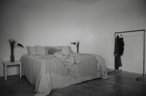 a bedroom with a bed with a blanket on it at Anzan Atitlan in San Marcos La Laguna