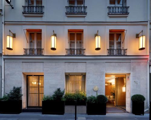 a facade of a building with windows and lights at Le Belgrand Hotel Paris Champs Elysees, Tapestry By Hilton in Paris