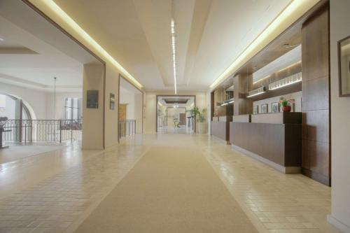 an empty hallway in a building with a lobby at Doubletree By Hilton La Torre Golf Resort in Roldán