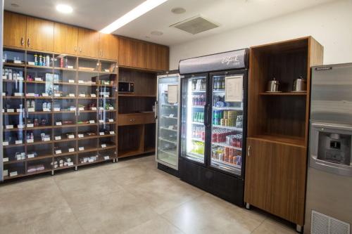 a room with a refrigerator and shelves of food at Hilton Garden Inn Ankara Gimat in Ankara
