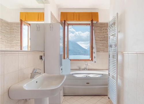 a bathroom with a tub and a sink and a bath tub at Varenna Wonders, Villa with pool for 14 guests in Perledo