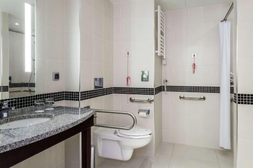 a bathroom with a toilet and a sink at Hampton by Hilton Warsaw Airport in Warsaw