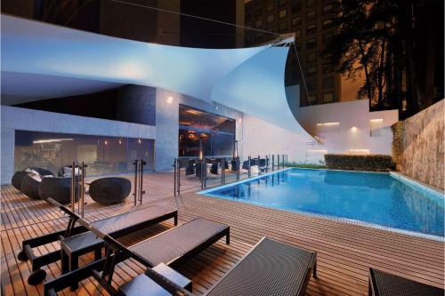 a swimming pool in a building at night at Hilton Bogotá in Bogotá