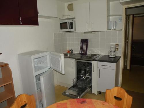 a small kitchen with a sink and a stove at Au Coeur De La Station in Les Deux Alpes