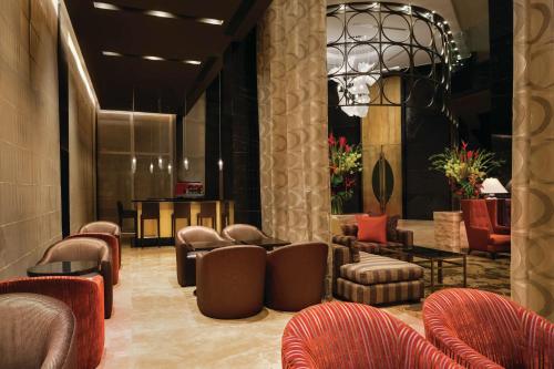 a lobby with couches and chairs and a waiting room at Hilton Lima Miraflores in Lima